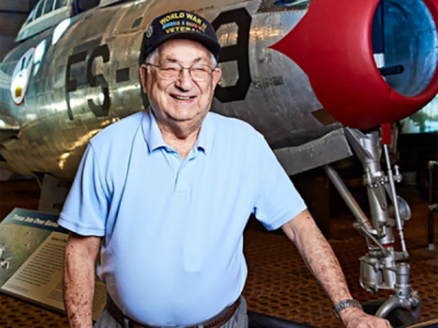 military veteran standing near old airplane