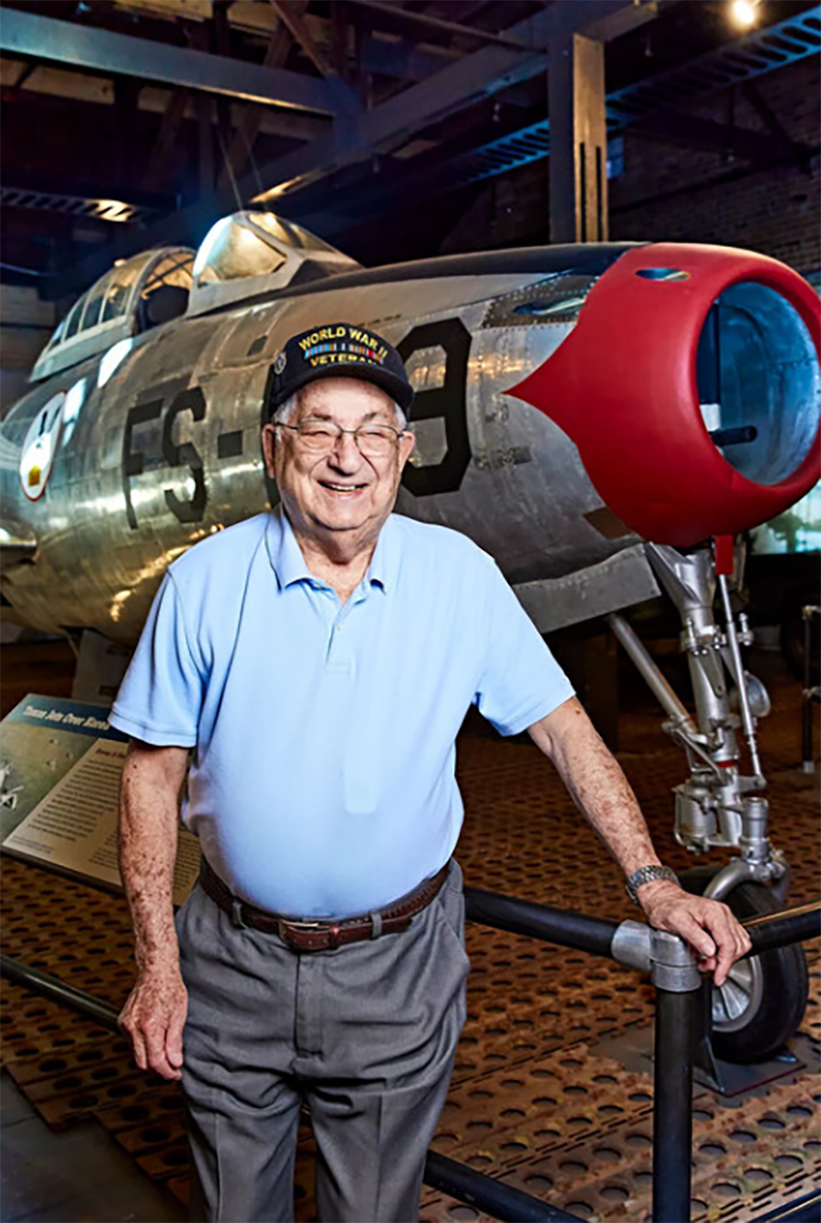 military veteran standing near old airplane