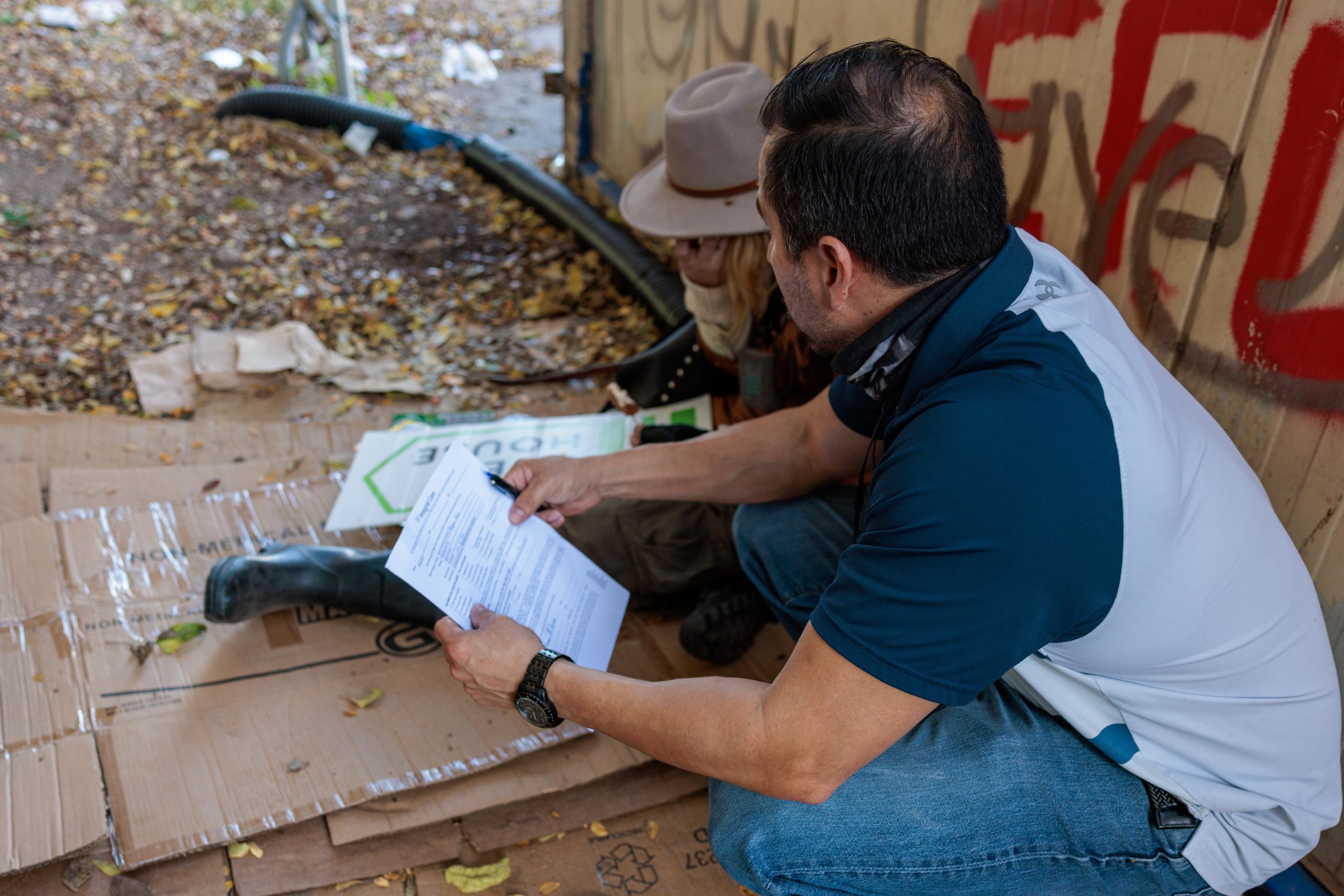 homeless person with volunteer