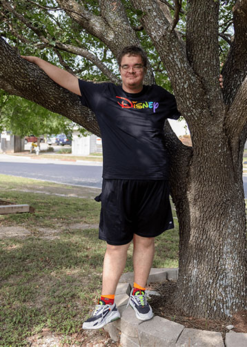 Michael standing outside next to an oak tree