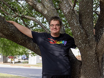 Michael standing outside next to oak tree