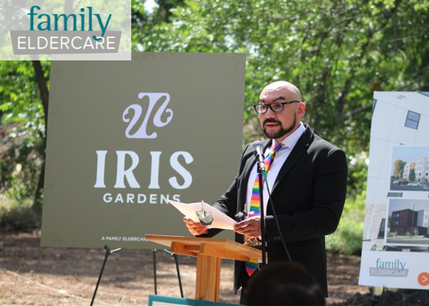Dr. Alarcon standing at podium of Iris Gardens groundbreaking