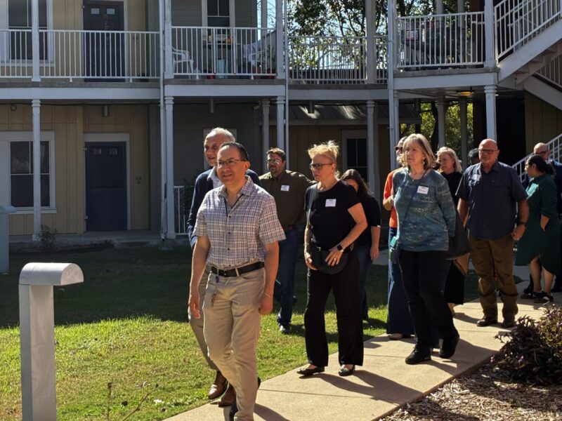 Group of people standing outside a housing community