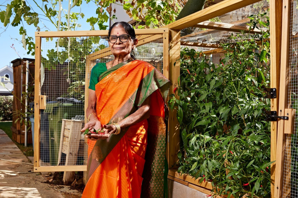 Honoree standing in front of garden.